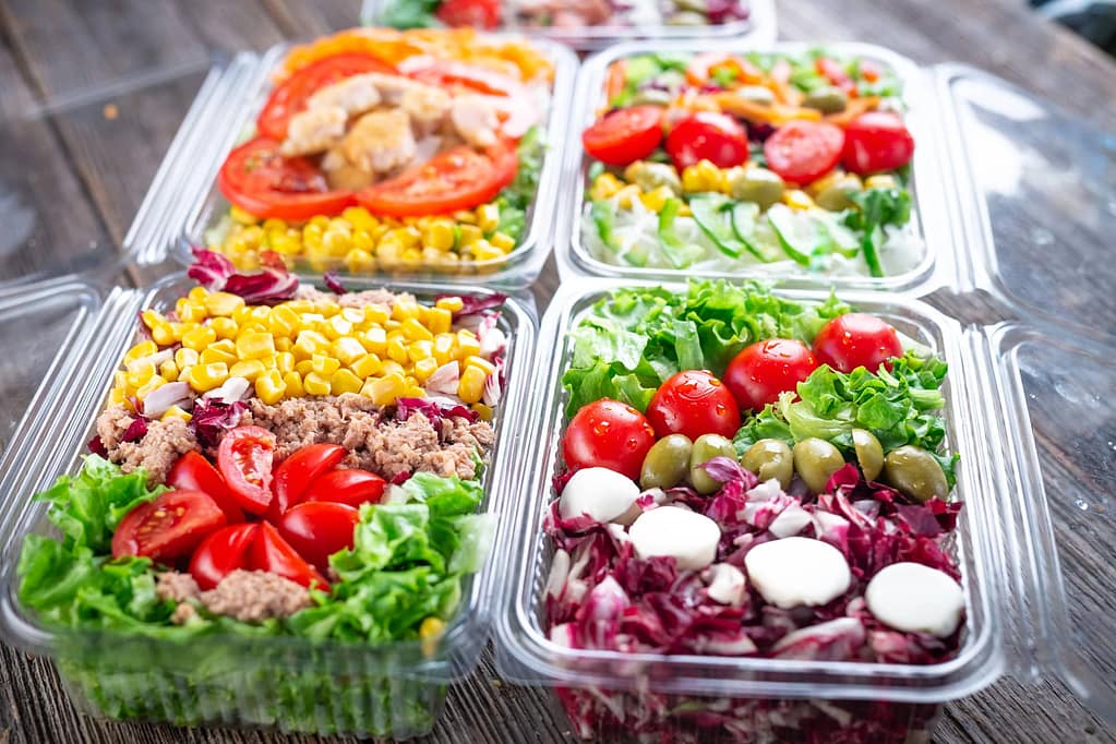 plastic trays of healthy salads
