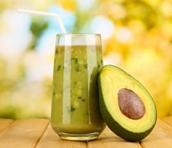 avocado fruit and avocado smoothie with straw
